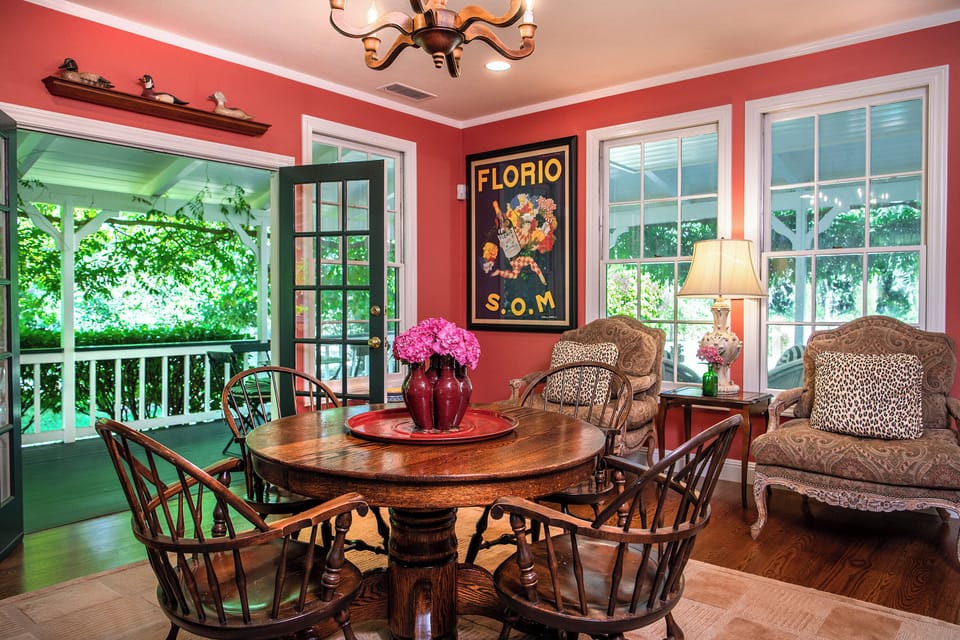 Great room with game table & comfortable sitting chairs; French doors to veranda