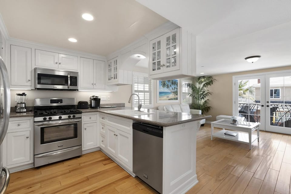 The kitchen comes stocked with dishes, utensils, cookware, bakeware, and major and small appliances.
                