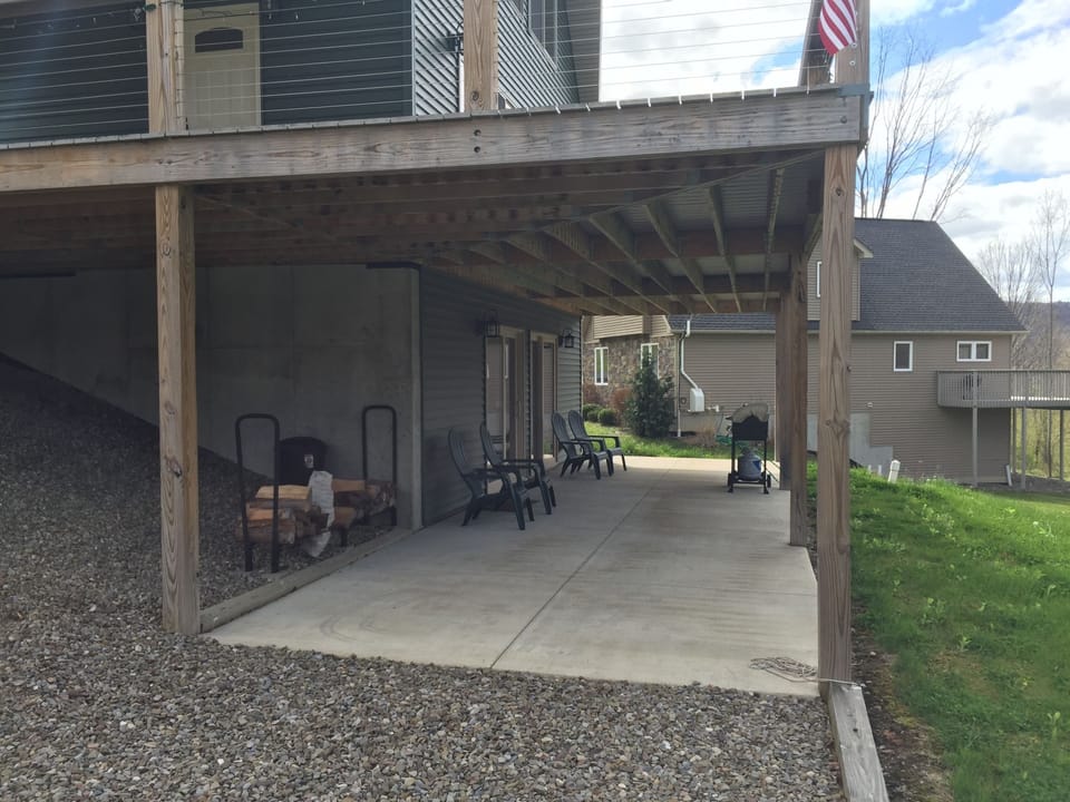 lower level deck, wood storage, close to fire pit. Access to rec room. 
