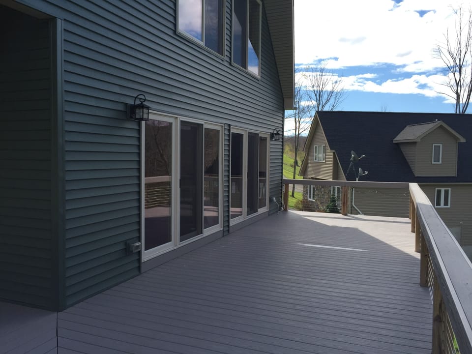 Front deck, w/out table, chairs and grill. Faces west, warm & sunny most days
