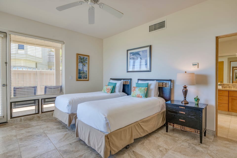 Twin beds in guest bedroom with ocean view.
