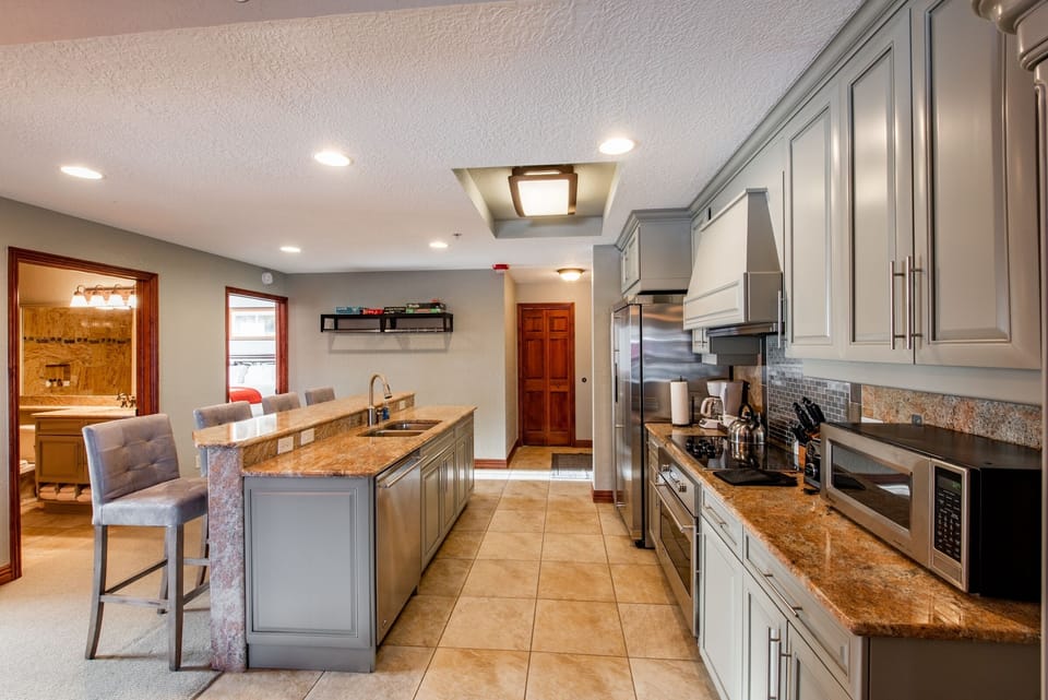 Kitchen has Plenty of Cupboard and Counter Space for Cooking Delicious Meals.