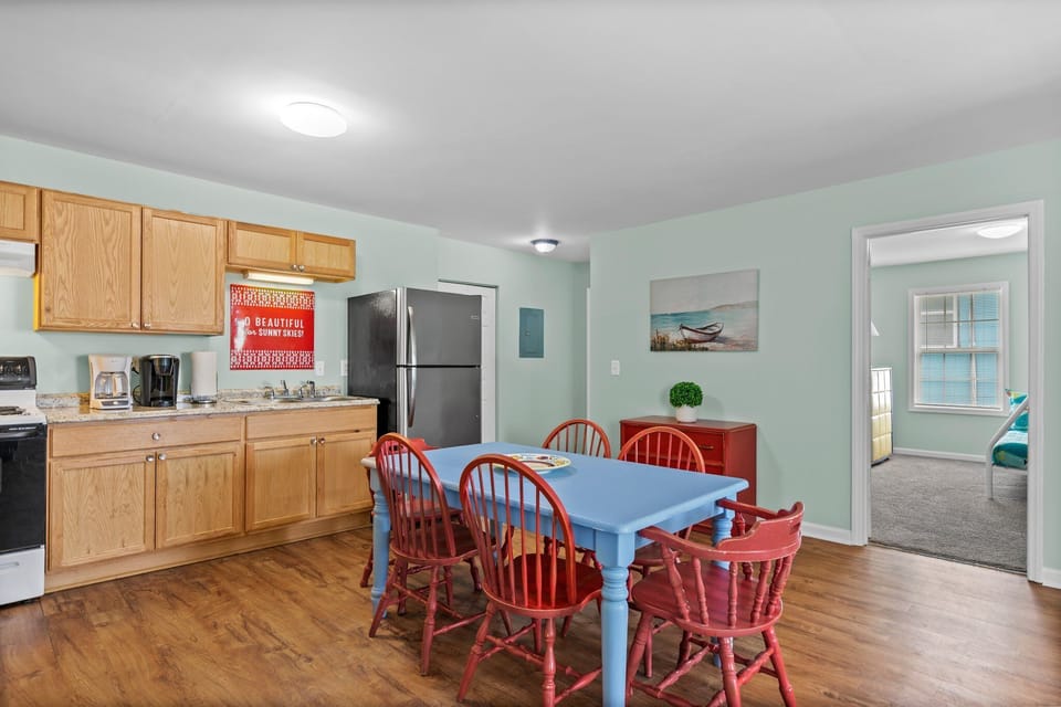 Your cheerful kitchen and dining space features warm wood floors, granite counters, and a charming blue table where you'll gather for memorable meals together.