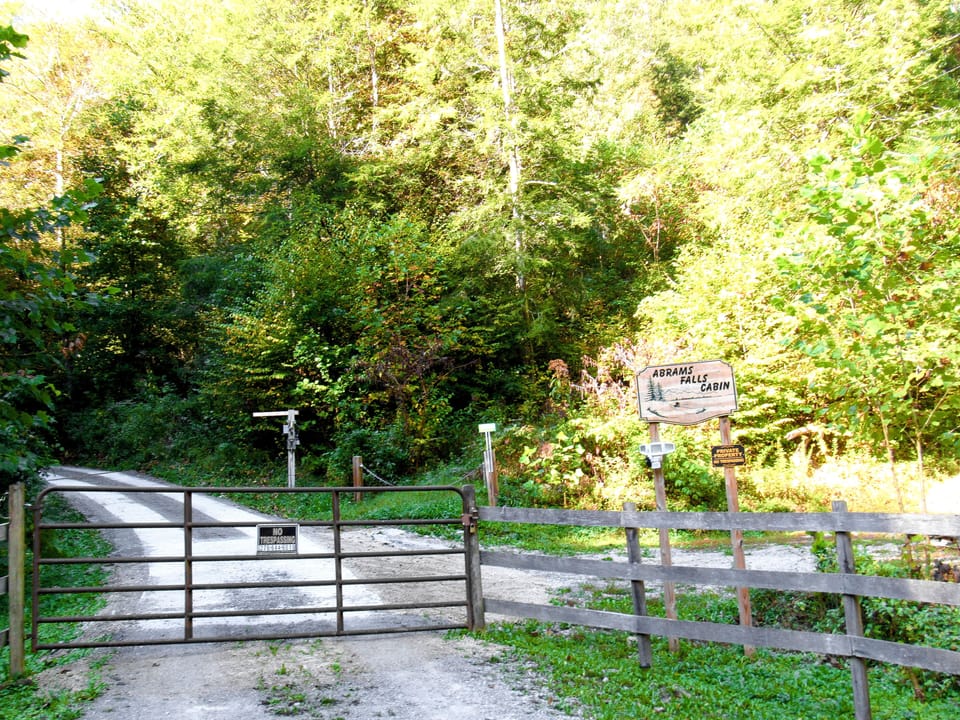 Driveway Entrance to the Cabin (inside view). Overflow parking lot to the right.