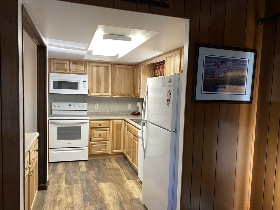 Kitchen off of the dining room. Coffee pot,microwave,dishwasher,stove & fridge. 