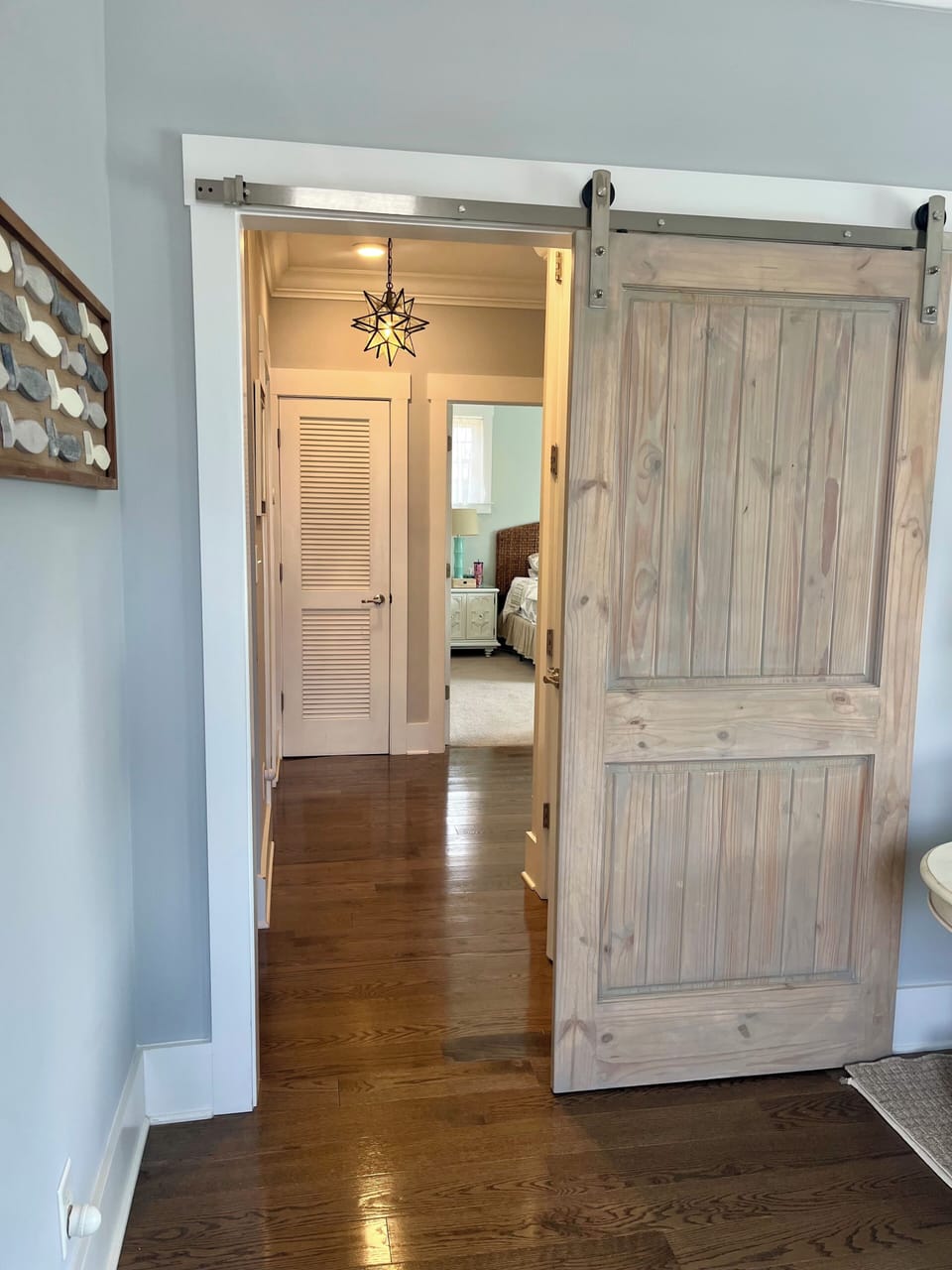 Slider barn door for privacy between lower family room and bedrooms