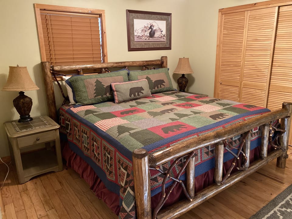 King bedroom downstairs with TV and full bathroom