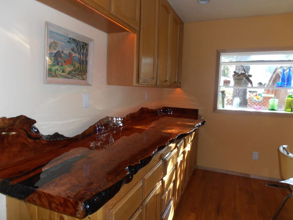 Our addition to the Kitchen is a redwood slab bar!
