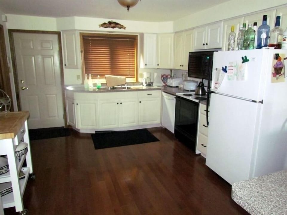 The modern kitchen is well-lit, spacious, and perfect for family gatherings.