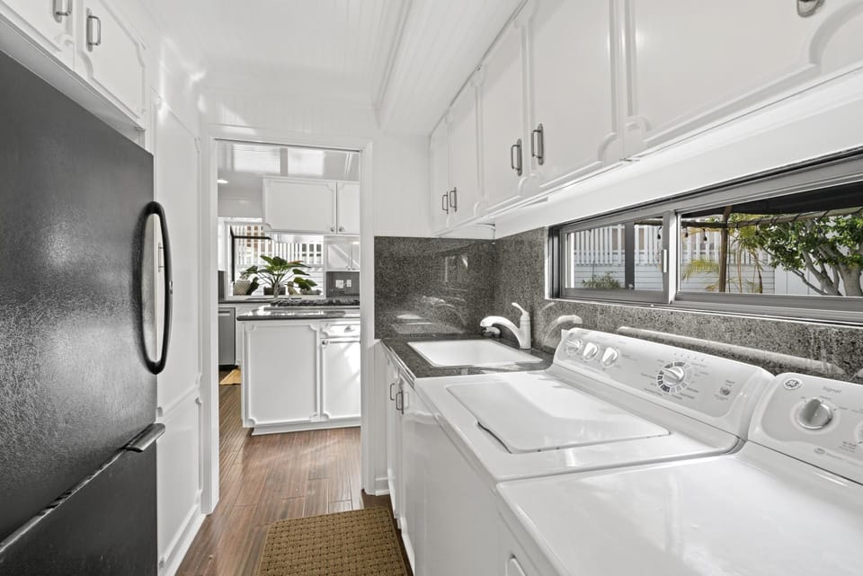 Off of the kitchen is the butler's pantry with secondary fridge and freezer, full laundry appliances, sink, and windows that look out to the courtyard.
                