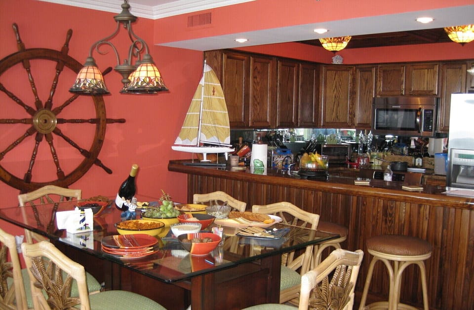 Dining table sits six plus four at the custom-made Cypress wood bar.
