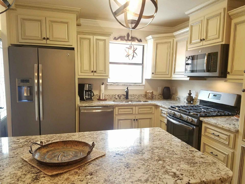 All new custom cream with glazed cabinetry.  New slate appliances & pantry.