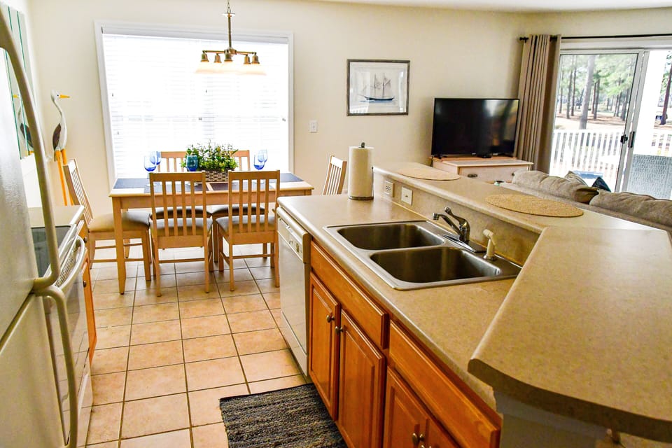 Villa galley style kitchen with breakfast bar.