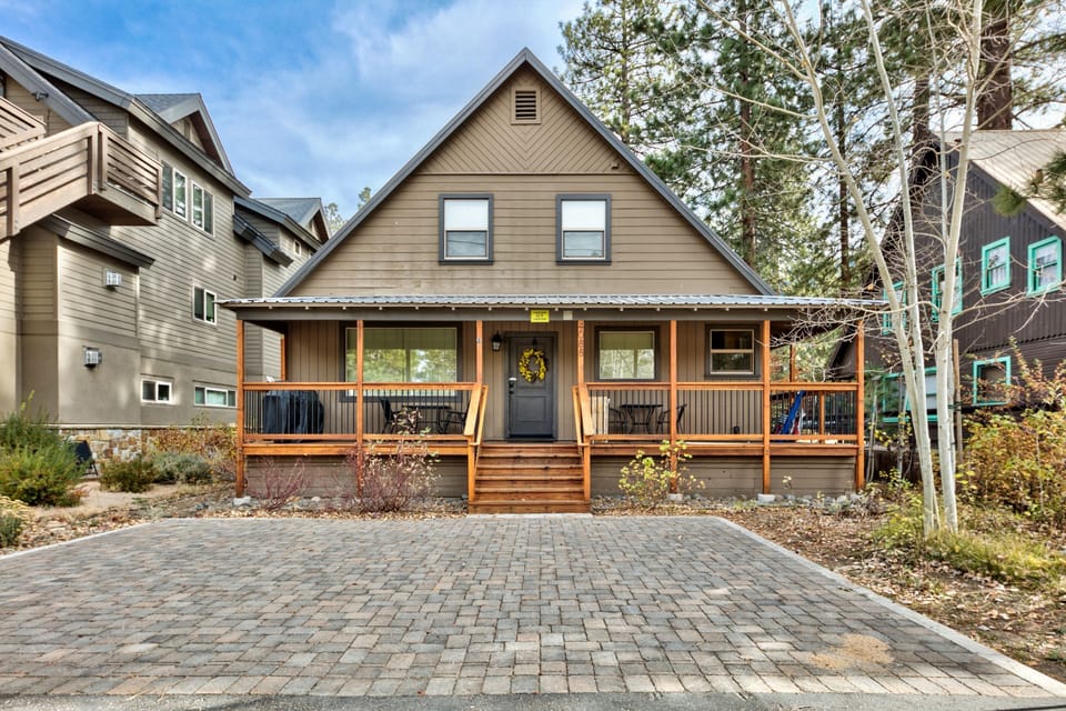 The home has room for two cars, a covered front porch, a BBQ grill, & seating.  