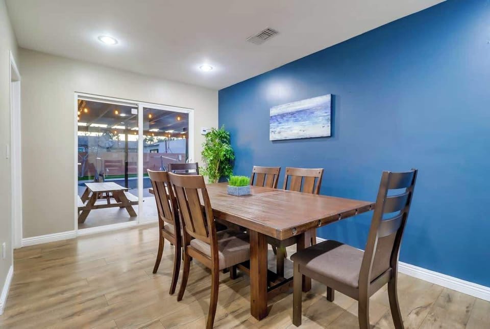 A full dining table adjacent to the kitchen also leads out to the backyard