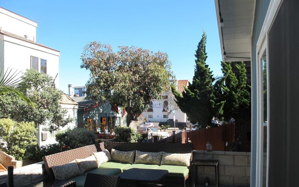 Patio looking East.  Enjoy comfortable couches, patio table and chairs.