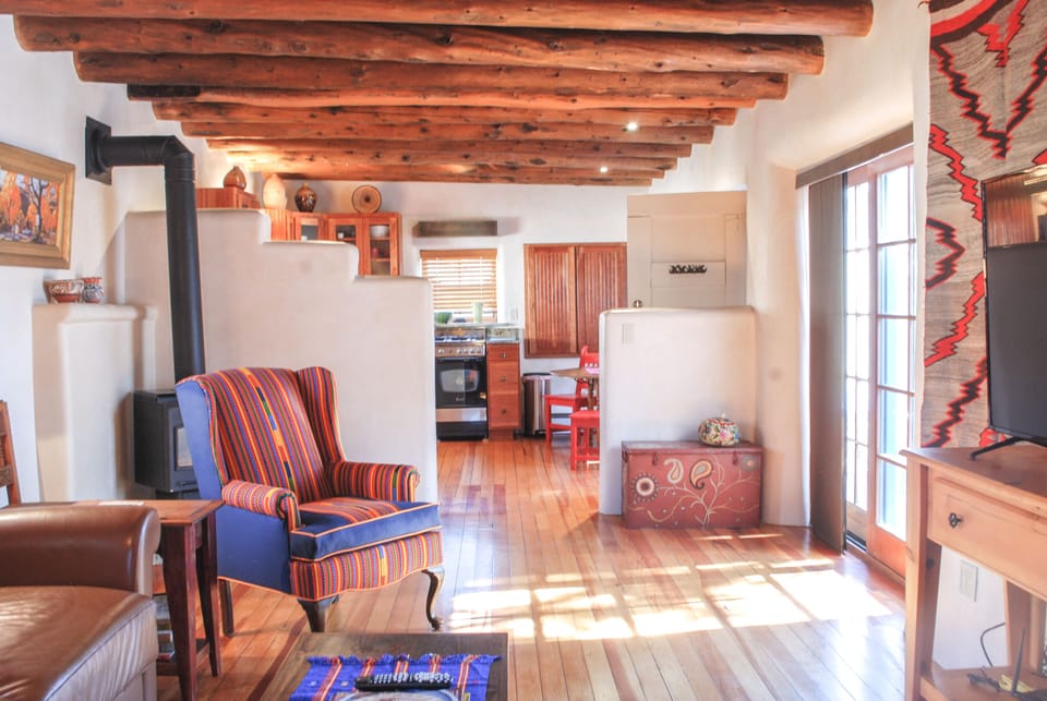 Living area with opens to kitchen and dining area. Private patio to right