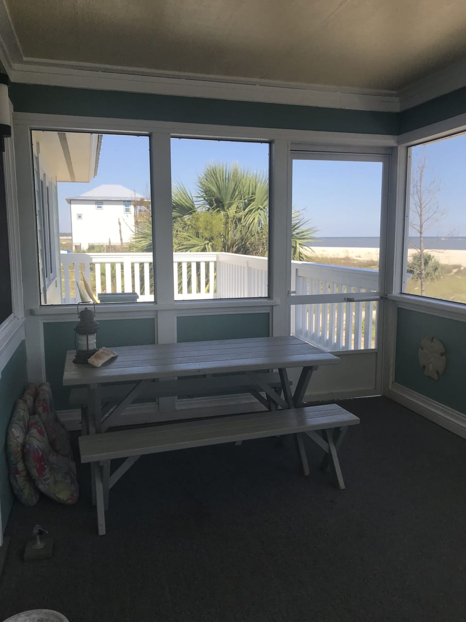 Picnic table on screened porch is great for eating meals & enjoying the Gulf.