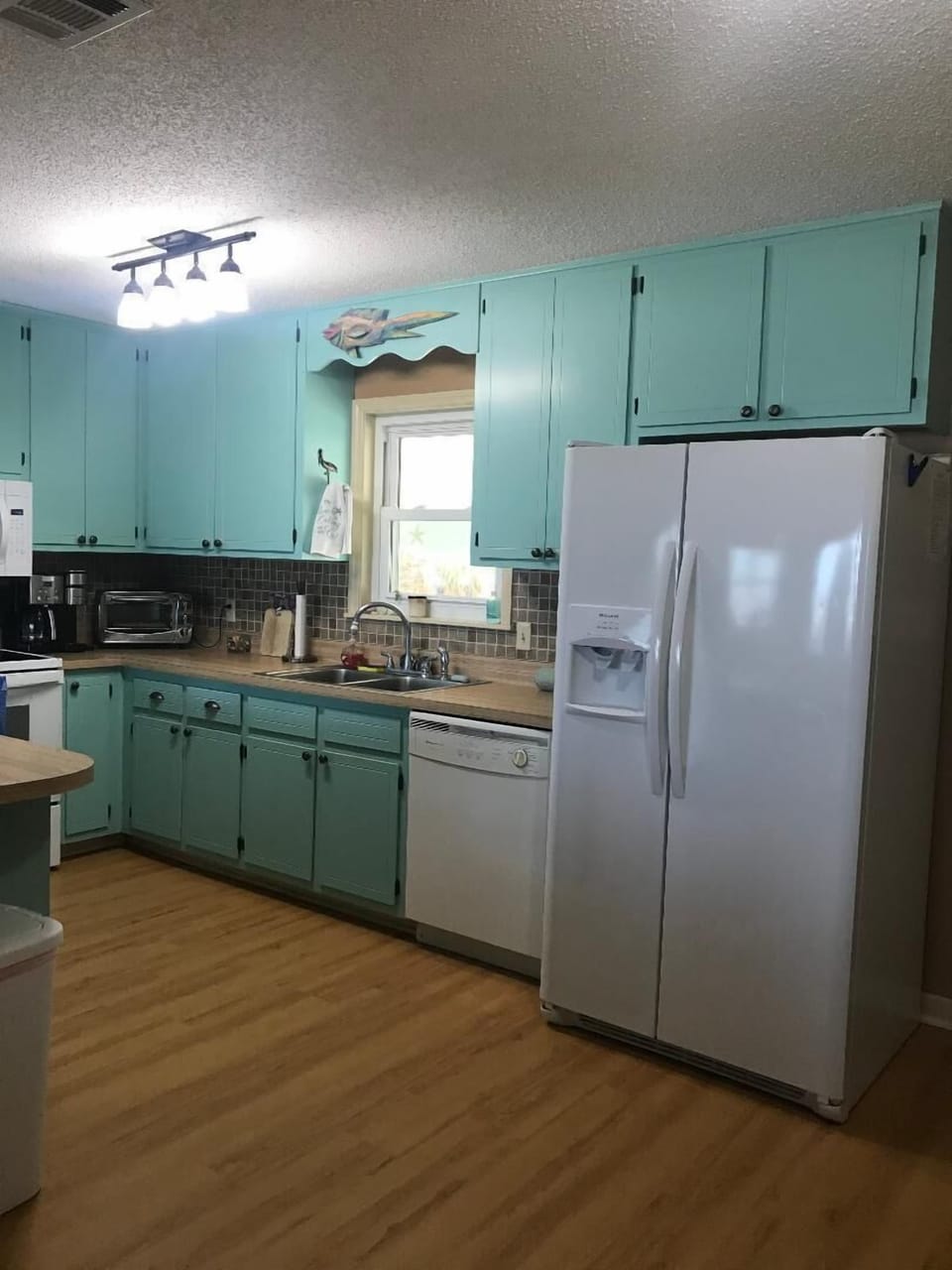 Kitchen is fully stocked with lots of cookware.