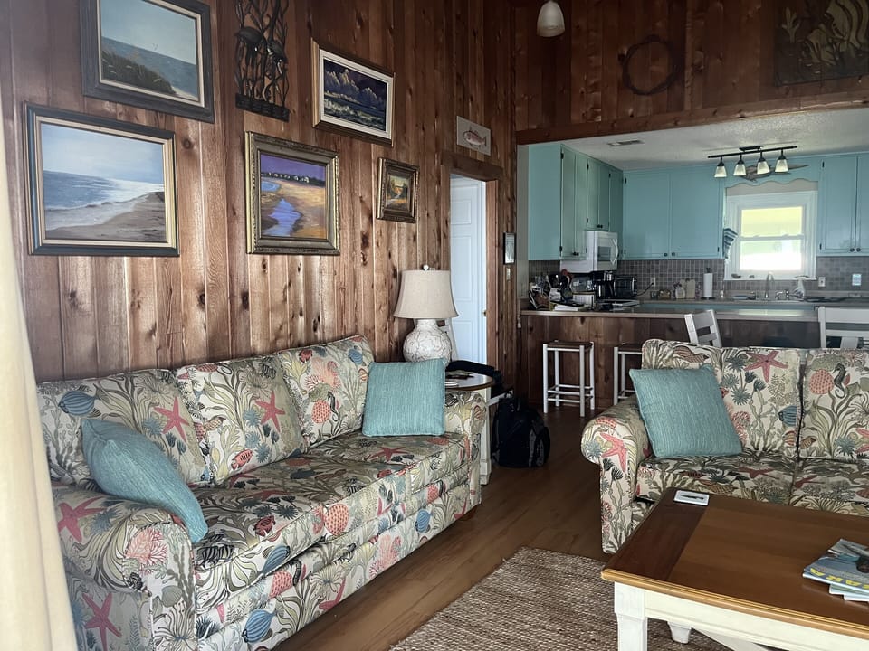 Family room has 2 lg sofas + oversize chair with ottoman