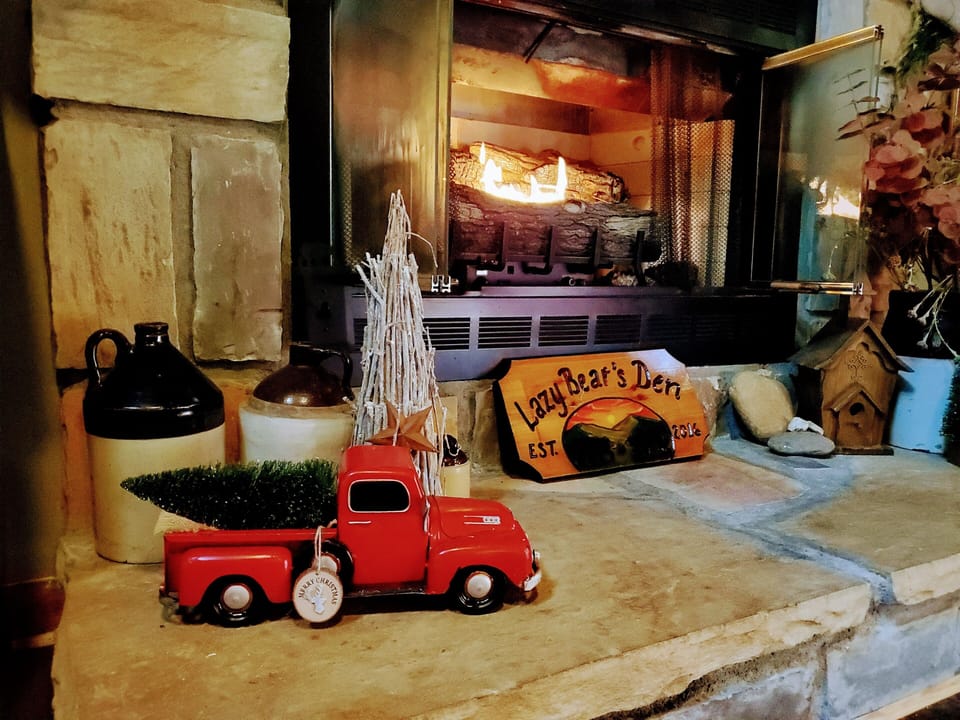 Lazy Bear's Den Christmas tree truck by the cozy fireplace
