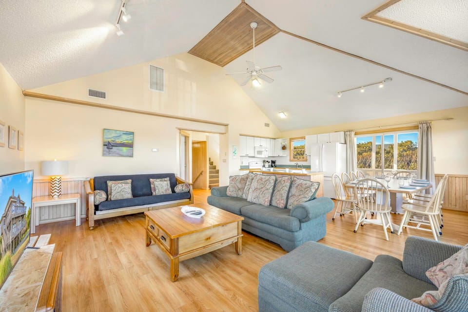 Relax in your spacious living area with comfy sofas, fully equipped kitchen, and dining space perfect for family gatherings.