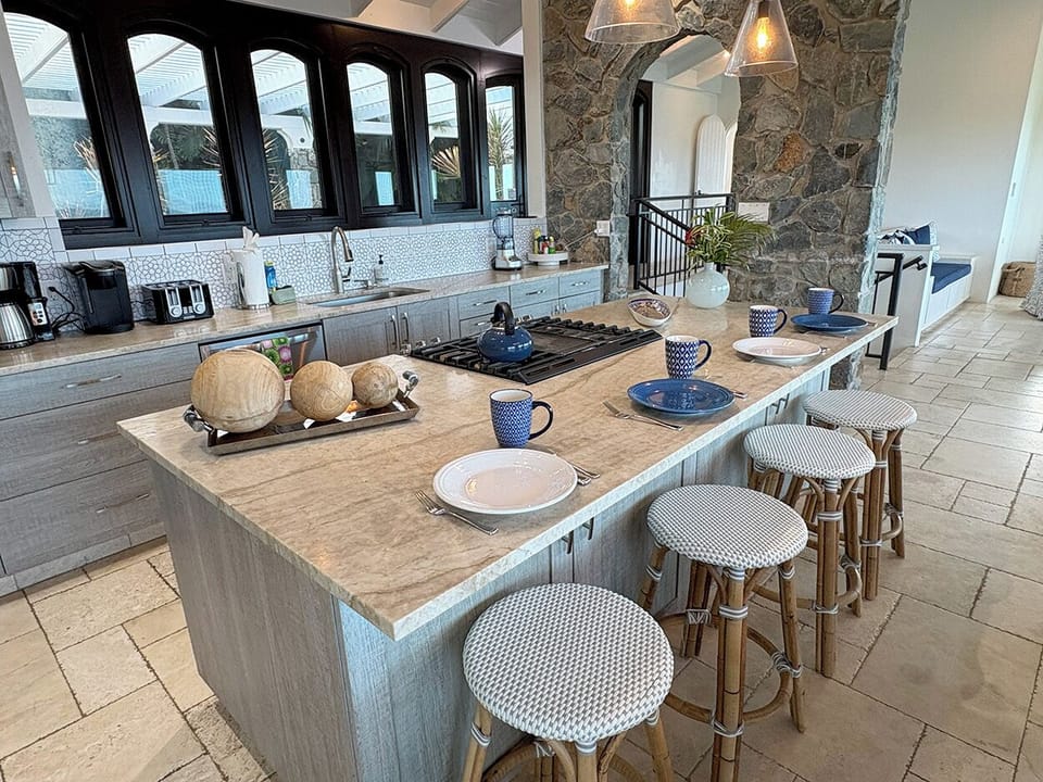 The kitchen island is a perfect spot to enjoy morning coffee as you plan your day