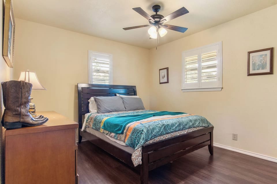 Another cozy haven!  This inviting bedroom at our vacation rental features a comfortable bed, warm lighting, and charming touches for a relaxing and peaceful night's sleep.