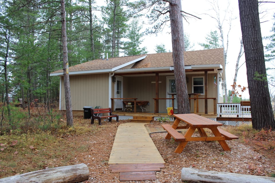 Side view with boardwalk extending around and down to the fire pit area.