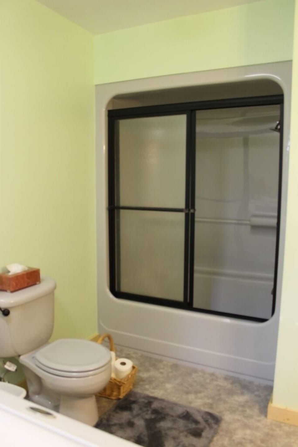 New tub/shower combo with glass shower doors.