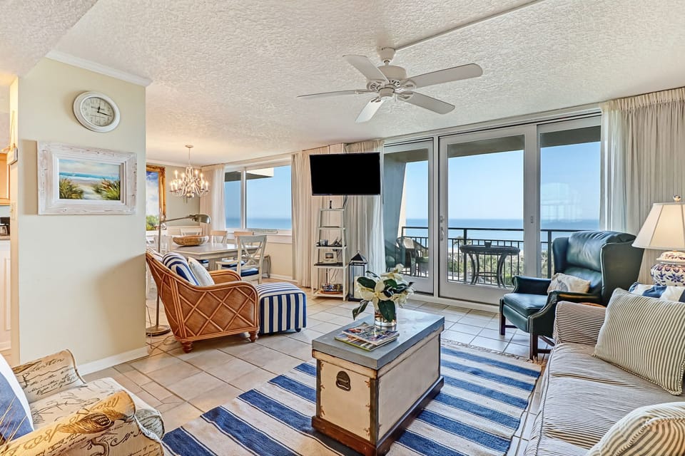 Picturesque Ocean Views from the Living Area with Ample Seating, Large Flat Screen TV and Balcony Access to Enjoy the Sunrise