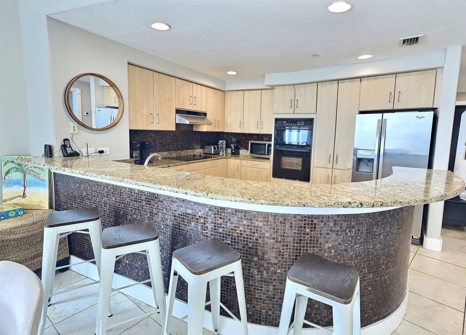 Fully stocked kitchen with wraparound granite bar.  Plenty of seating!
