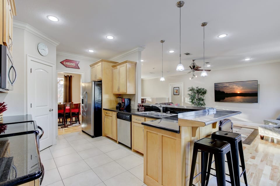 Kitchen open to formal, living, and breakfast area. Bar seats 6.