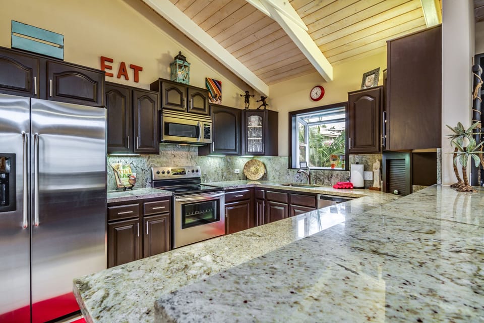Kitchen with upgraded granite counters and stainless steel appliances. 