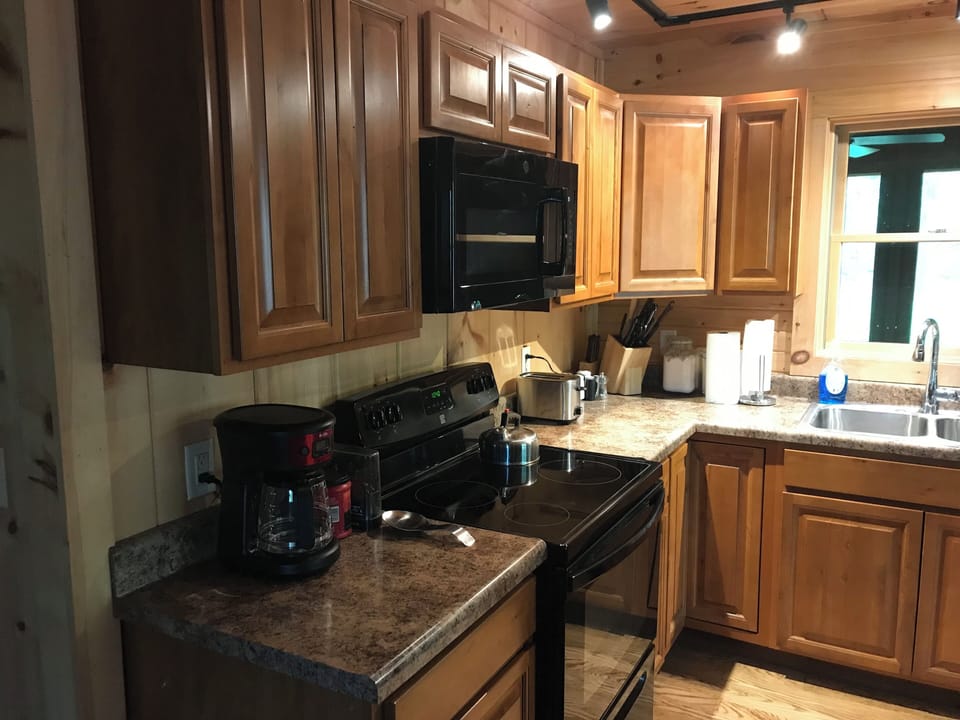 Kitchen.  Microwave over the stove, coffee maker, toaster