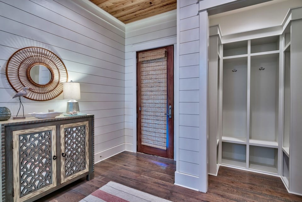 1st floor entry hall.  Pecky cypress wood ceiling & oak floors. Storage lockers.