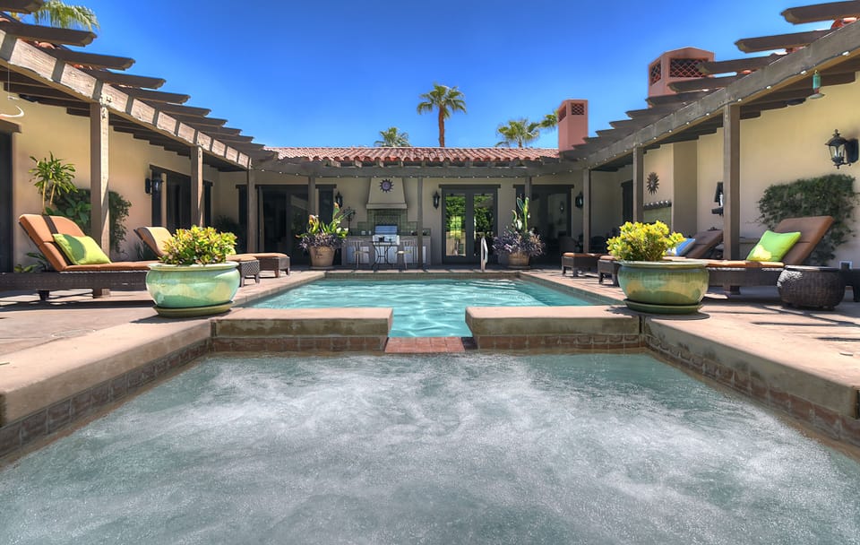 Outdoor terrace with misters, professional grade grill/prep island and fireplace