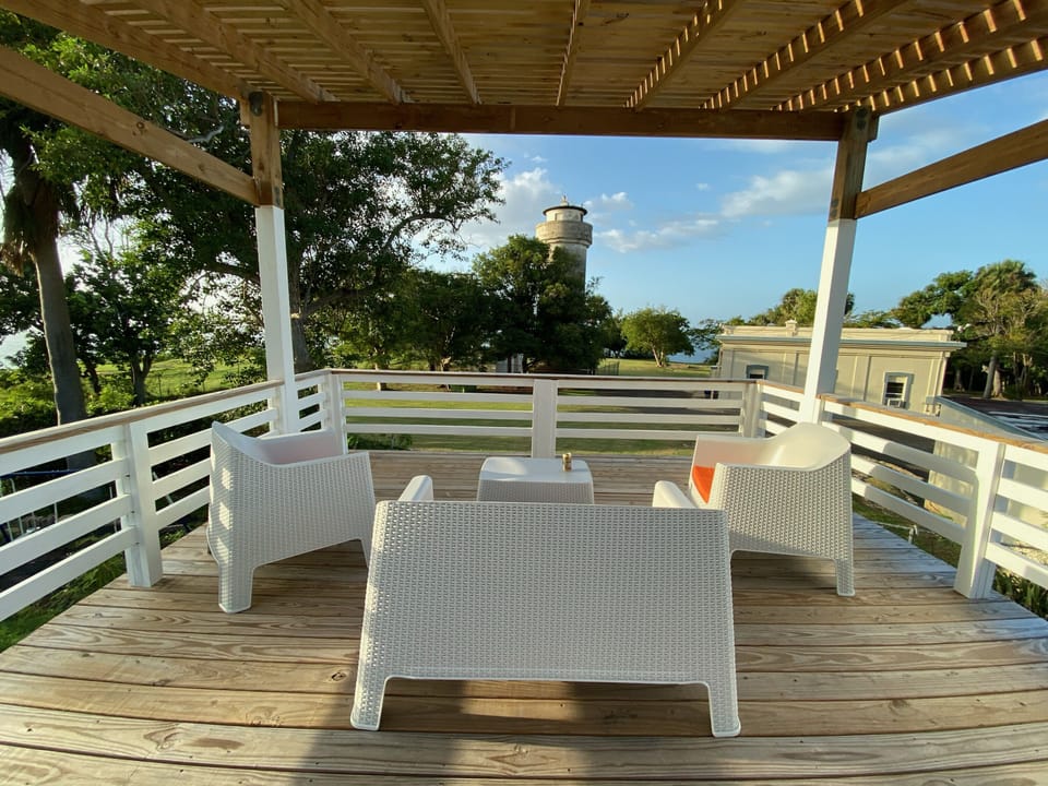 Ocean, lighthouse, and golf course views from the backyard pergola.