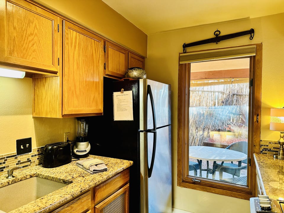 Kitchen with view of fenced in yard with table and chairs
