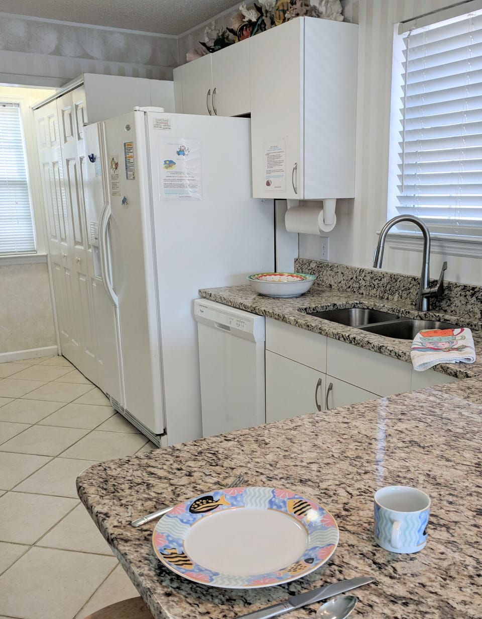Kitchen sink area toward washer/dryer 