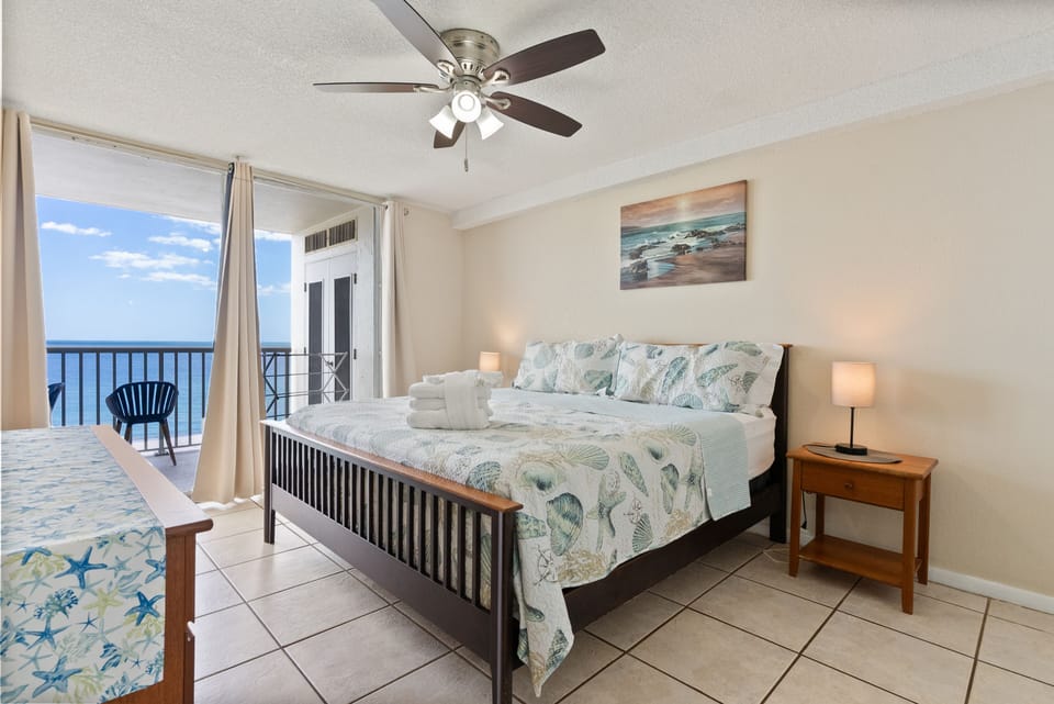 Master bedroom king bed overlooking private balcony