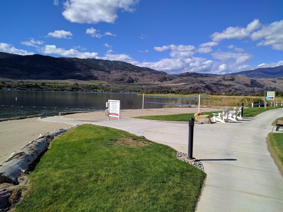 Beach with volleyball net and off-leash dog area