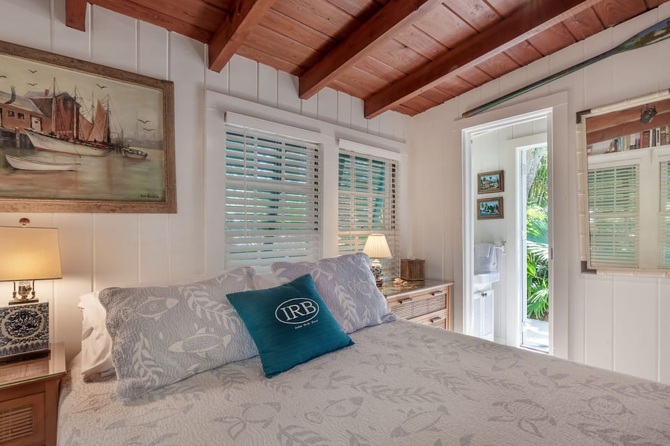 Second queen bedroom and entrance to half bath and door to the exterior.