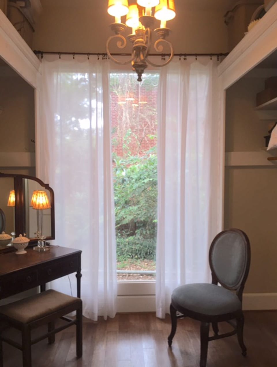Large dressing room with makeup table off bedroom.