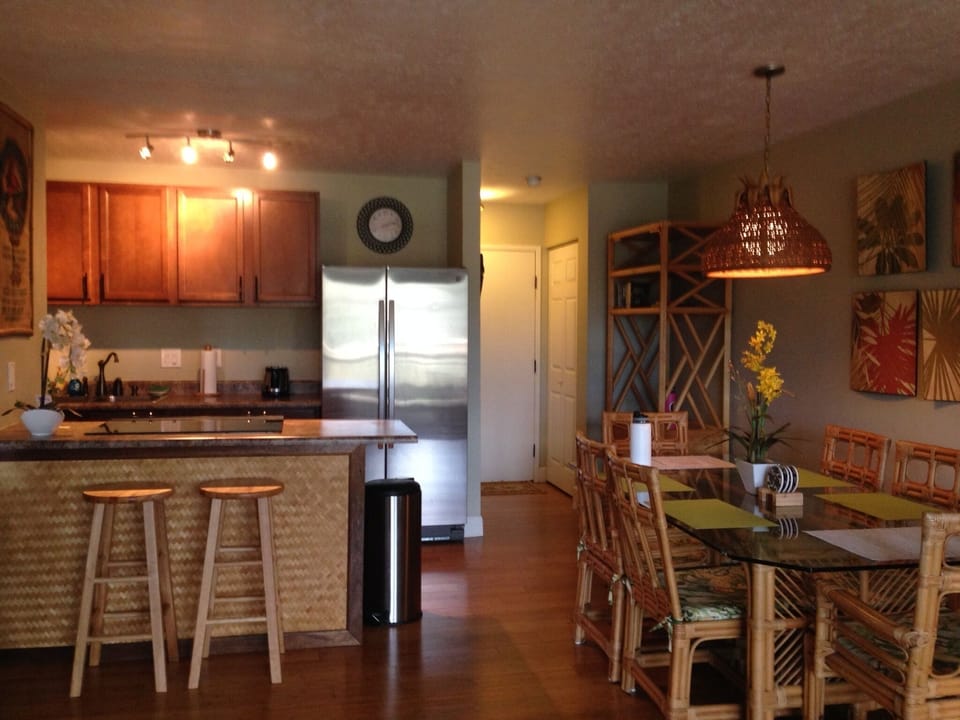 kitchen w brand new refrigerator and dining area with new ceiling lamp