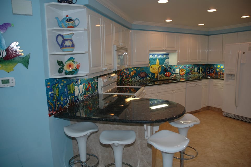 Breakfast bar seats four more. The mosaic back splash inundates with color.