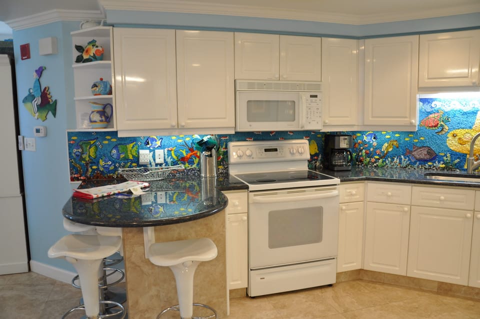 New appliances. Open floor plan. Travertine tile in living area. Handmade mosaic