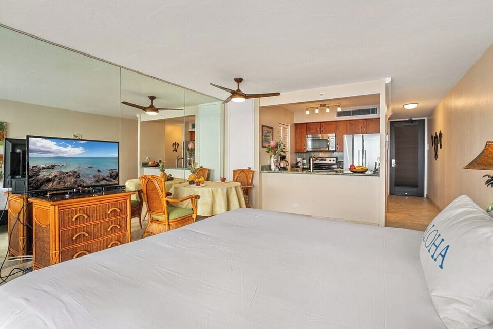 A practical and inviting studio featuring a king bed and a modern kitchen setup