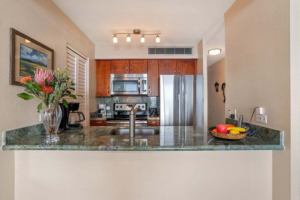 Fully equipped kitchen featuring stainless steel appliances and elegant granite countertops