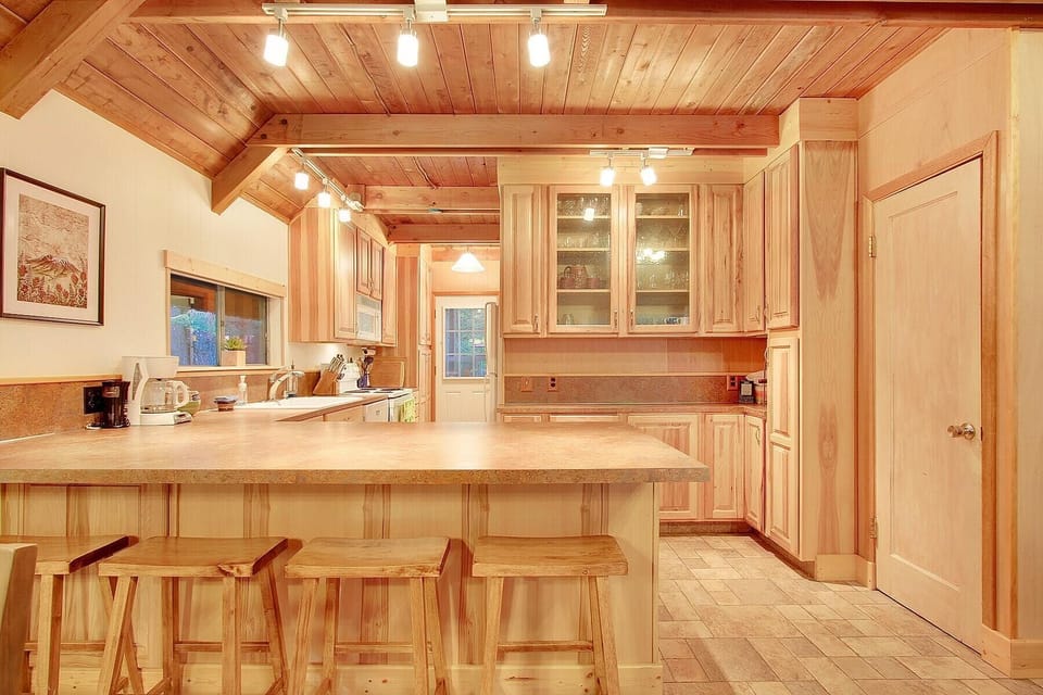 Kitchen leads to back door & yard. Laundry hut is outside to the left.